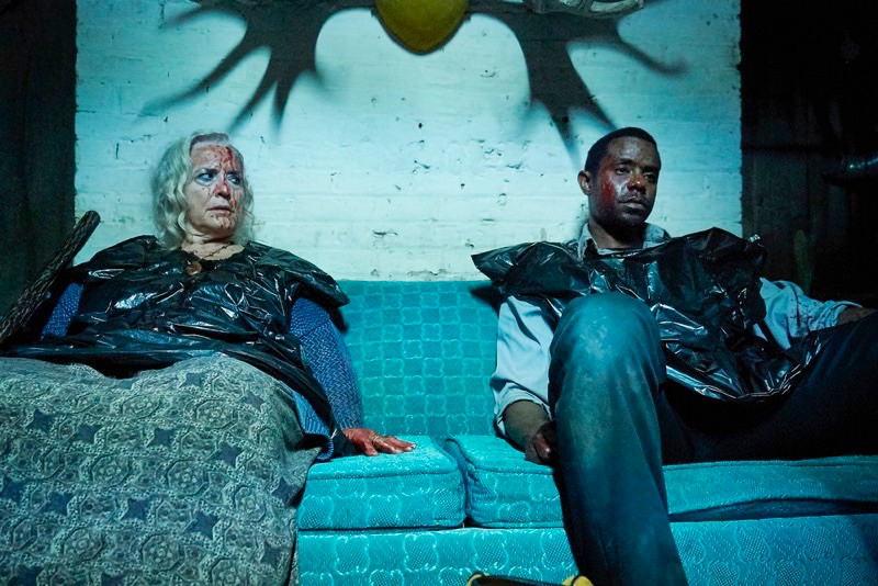 Former foes Louise (Krisha Fairchild) and Luke (Brandon Scott) share a bloody bonding moment.